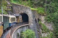 nostalgic train ride in the swiss mountains into a tunnel on the railway line davos - filisur. Locomative in the alps Royalty Free Stock Photo