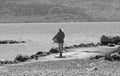 Nostalgic woman by the sea in black and white Royalty Free Stock Photo