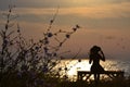 Nostalgic woman siting on a bench by the sea