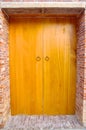 Nostalgic wooden door and red brick wall Royalty Free Stock Photo