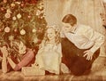 Nostalgy Christmas family with child girl dressing Christmas tree.