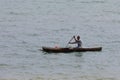 Malagasy man on sea in traditional handmade dugout wooden boat