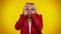 Nosy curious senior granny woman closing eyes with hand, spying through fingers, hiding, peeping Royalty Free Stock Photo