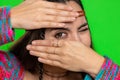 Nosy curious young woman girl closing eyes with hand and spying through fingers, hiding, peeping Royalty Free Stock Photo