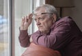 Nosy neighbor looking at something out of his window Royalty Free Stock Photo