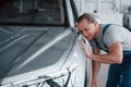 Not bad at all. After professional repairing. Man looking at perfectly polished silver colored car