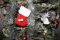 Small red slipper, hung on collided on a branch of the Christmas tree. - Front view Royalty Free Stock Photo