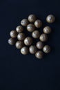 Not broken macadamia nuts on a black background in the group