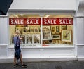 NOT closing down sale sign, following lockdown easing, in picture shop window in Bath, Somerset, UK