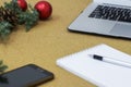 Not completed list of goals in a notebook on a wooden table with Christmas decorations and a laptop Royalty Free Stock Photo