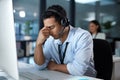 Not every call has a happy ending. a young man using a headset and looking stressed in a modern office.