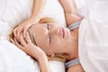 Not a good time to wake. A beautiful young woman sleeping in her bed. Royalty Free Stock Photo