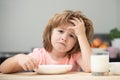 Not hungry. Kid refusing to eat. Child have no appetite. Upset little kid refuse to eat organic cereals with milk. Child Royalty Free Stock Photo