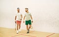 Not just teammates, theyre best mates. two young men chatting after playing a game of squash. Royalty Free Stock Photo