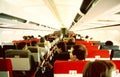 USAir Passenger aircraft cabin in flight with people, Not much room between Aisle seats in this 1960\