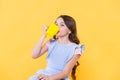 Not my cup of tea. Making sip. Drink enough water. Girl kid hold mug yellow background. Lovely child hold mug. Drinking Royalty Free Stock Photo