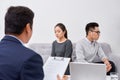 It is not my fault! Displeased young man talking to psychiatrist and gesturing while his wife sitting near him and keeping arms Royalty Free Stock Photo