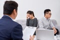 It is not my fault! Displeased young man talking to psychiatrist and gesturing while his wife sitting near him and keeping arms Royalty Free Stock Photo