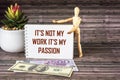 This is not my job, this is my passion. Inspirational quote on a notebook, near money, a wooden doll Royalty Free Stock Photo