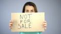 Not for sale sign in woman's hands, sexual slavery, human trafficking, assault Royalty Free Stock Photo