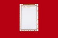 Not a standard notepad with a clip-on white paper holder on a red background Royalty Free Stock Photo