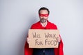 Not superman anymore. Photo of stressed displeased mature business guy super hero costume hold carton placard need job