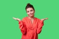 Not sure! Portrait of uncertain confused woman with bun hairstyle, big earrings and in red blouse. indoor studio shot isolated on Royalty Free Stock Photo