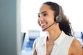 Not to worry, Im here to help. an attractive young call centre agent sitting alone in the office and using her computer. Royalty Free Stock Photo