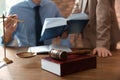 Notaries working at table in office, focus on judge gavel and book Royalty Free Stock Photo