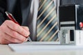 A notary or a lawyer signs the document. A fountain pen in a man`s hand. Royalty Free Stock Photo