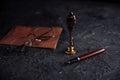 Notary public tools: old notarial wax seal, pen, glasess and envelope on a table