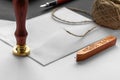 Notary public wax stamper. White envelope with brown wax seal, golden stamp. Responsive design mockup, flat lay. Still life with Royalty Free Stock Photo