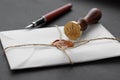 Notary public wax stamper. White envelope with brown wax seal, golden stamp. Responsive design mockup, flat lay. Still life with