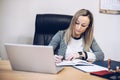 A notary, a woman lawyer works in her office, records appointments