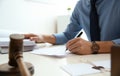 Notary working with papers and judge gavel on table. Law and justice concept Royalty Free Stock Photo