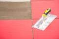 Notched trowel on red tiles