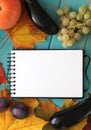 Note book and composition of vegetables on blue wooden desk. Royalty Free Stock Photo