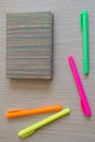 Note book and four colored Markers. Royalty Free Stock Photo