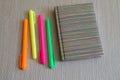 Note book and four colored Markers. Royalty Free Stock Photo