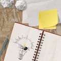 Note book with hand drawn light bulb and THINK word design Royalty Free Stock Photo