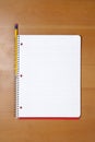 A note book and pencil on a desk Royalty Free Stock Photo