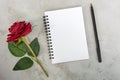 Note book with red roses and pen on marble desk. Top view. Flat lay. Copy space. Royalty Free Stock Photo