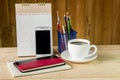 Note book,smart phone,coffee cup,and stack of book with calendar Royalty Free Stock Photo