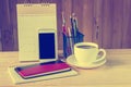 Note book,smart phone,coffee cup,and stack of book with calendar Royalty Free Stock Photo