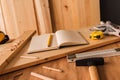 Note book and tools on woodwork workshop desk Royalty Free Stock Photo
