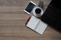 Note books, pens, coffee, mobile phones and laptop are placed on table wooden Royalty Free Stock Photo