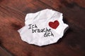 Note `Ich brauche dich` on torn slip of paper