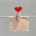 Note on kraft paper with pin in the shape of heart Royalty Free Stock Photo