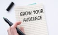Note with the message of share your audience, with desk background Royalty Free Stock Photo