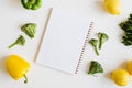 Note pad with blank pages and fresh vegetables and fruits on white background Royalty Free Stock Photo